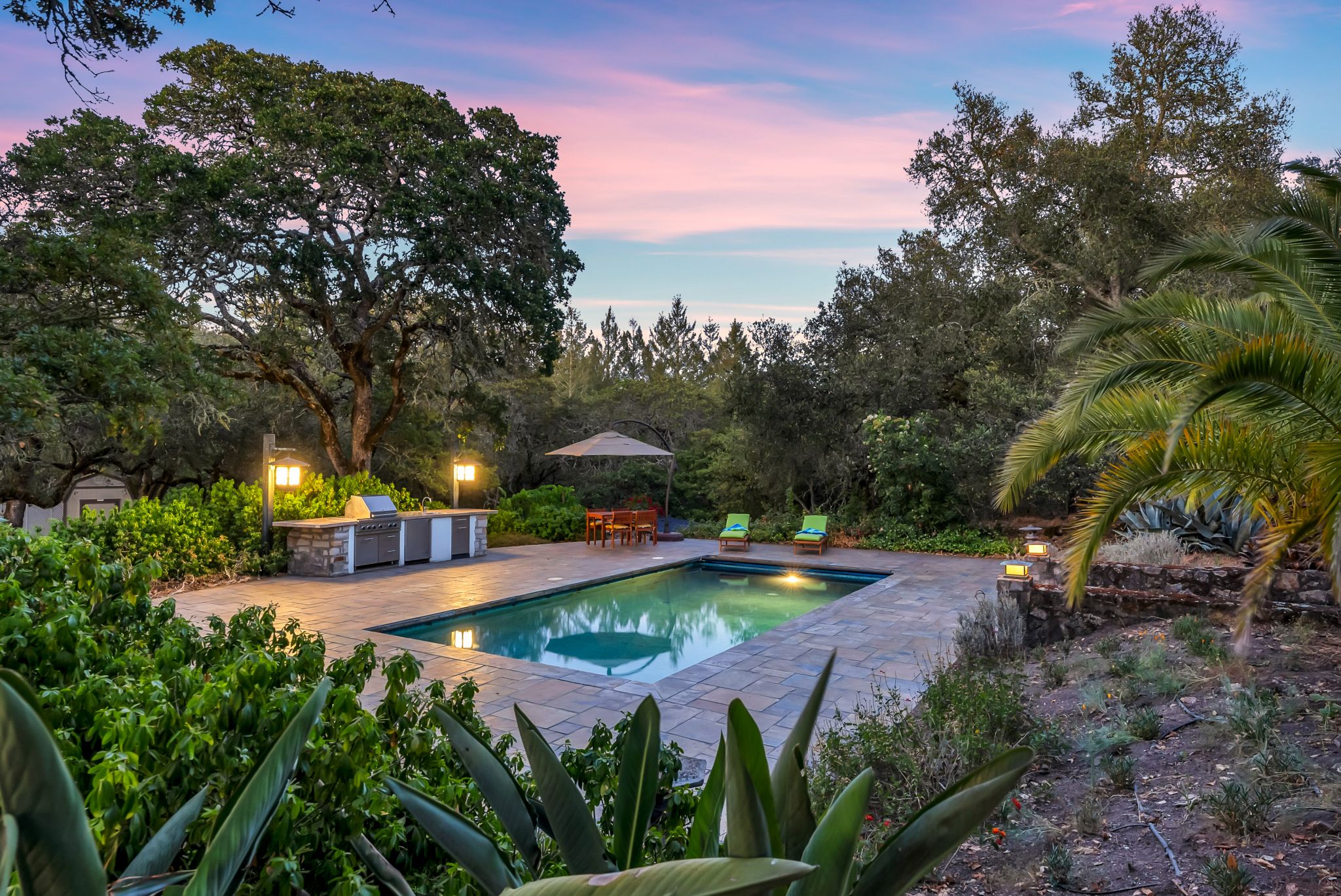 The pool, surrounded by palms, is a private oasis. An outdoor kitchen and patio complete the serene setting. Anna Marie Erwert writes from both the renter and new buyer perspective, having (finally) achieved both statuses. She focuses on national real estate trends, specializing in the San Francisco Bay Area and Pacific Northwest. Follow Anna on Twitter: @AnnaMarieErwert.