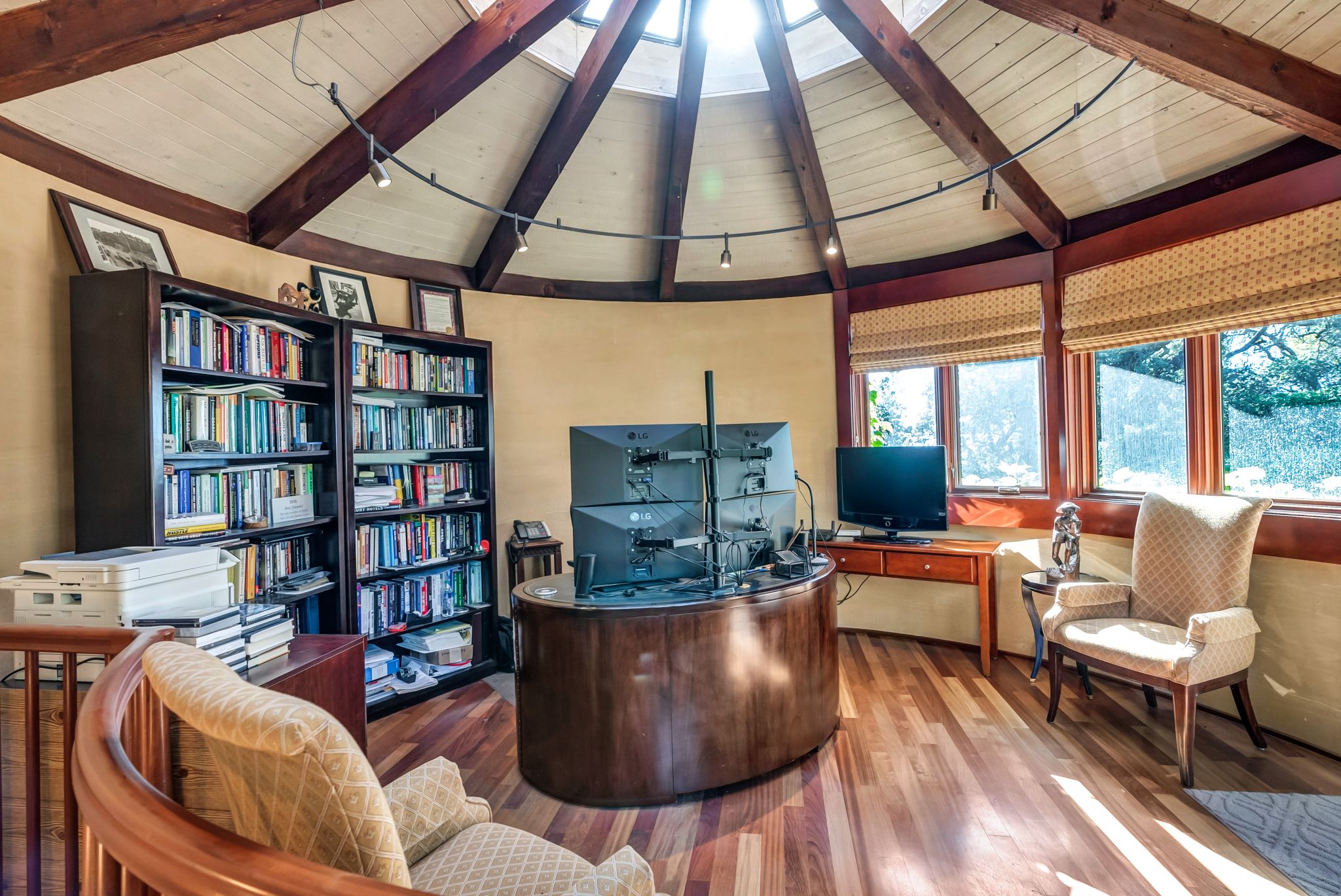 An office and library under this conical ceiling and skylight make for a unique work-from-home experience.