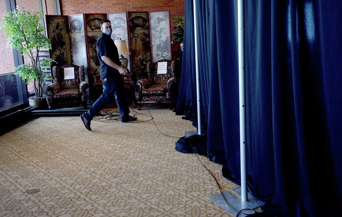 Staff set up for an event on the eighth floor Thursday night at the Mary and John Gray Library, where damage remains after Hurricane Delta blew out some of the eighth floor windows and water damage was evident on nearly every floor. Photo taken Thursday, October 15, 2020 Kim Brent/The Enterprise
