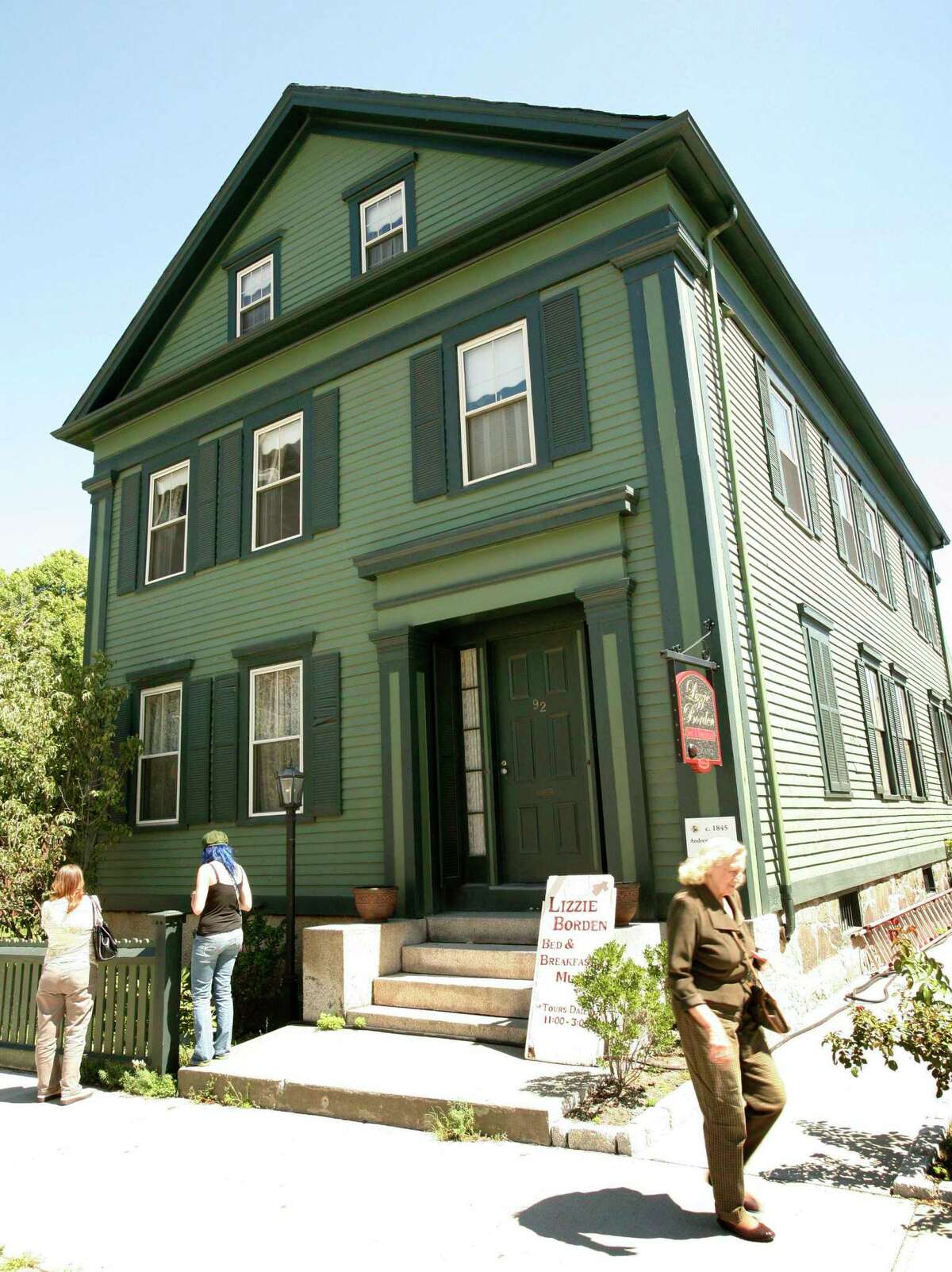 In this Aug. 20, 2008 photo, passers-by walk in front of the Lizzie Borden Bed and Breakfast, in Fall River, Mass.
