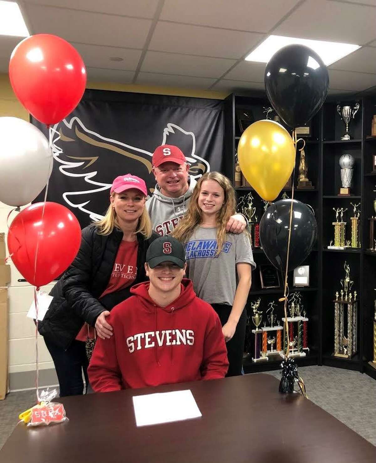 Shea Grant is surrounded by mom Stacey, dad Tim and sister Keira. He will play lacrosse at Stevens Institute of Technology. Twin sister Keira will play at the University of Delaware.