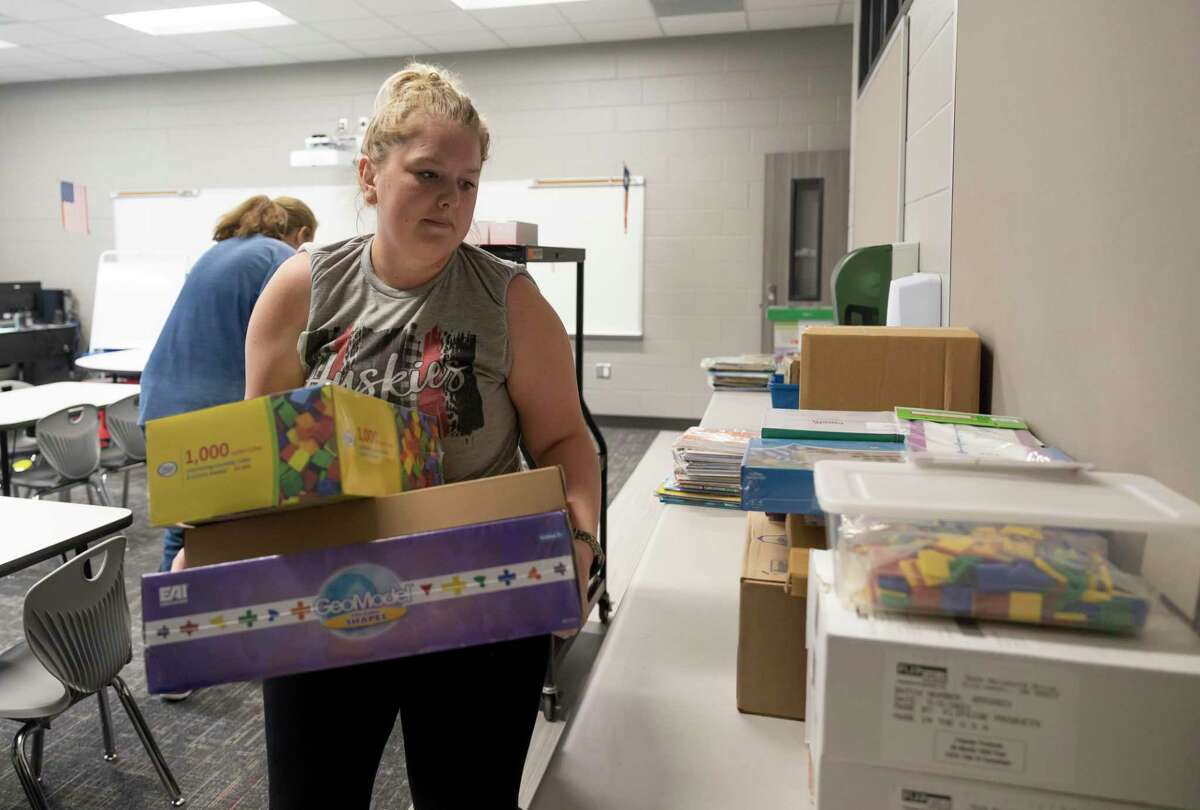 Kaitlin Springer, kindergarten teacher, lays boxes of supplies in a classroom at the new Hope Elementary.