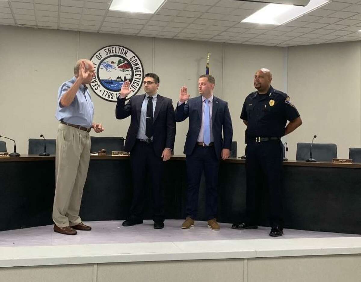 Mayor Mark Lauretti swears in new police officers Leonard Scinto and Colin Bitsco Tuesday, July 27, at City Hall as police Chief Shawn Sequeira looks on.