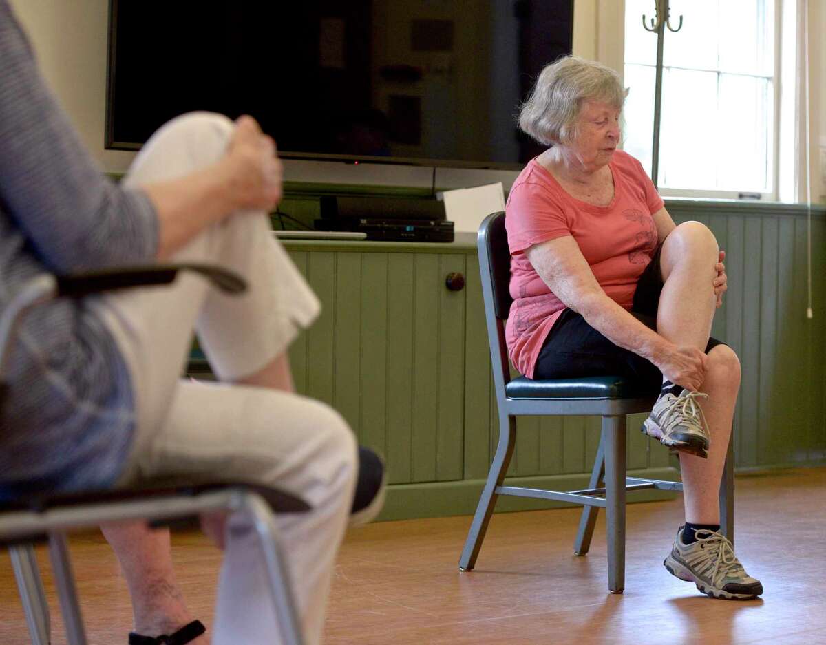 Class leader Janet Wey, of Sherman, instructs the class in a stretch during the morning exercise club at the Sherman Senior Center, Thursday, July 29, 2021, in Sherman, Conn. The town’s Commission on Aging is seeking up to $2,500 for a preliminary feasibility analysis of a potential site of a new senior center.