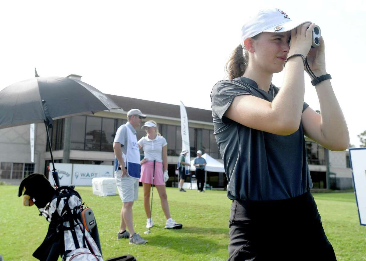 Lamar University's Alessia Trebbi-Tindall uses a scope to. gauge position of the green before teeing off during the Women's All Pro Tour golf tournament at the Beaumont Country Club Tuesday. Several local and regional golfers competed in the event. Photo made Tuesday, July 27, 2021 Kim Brent/The Enterprise