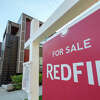 A Redfin real estate yard sign is pictured in front of a house for sale on October 31, 2017 in Seattle, Washington. 