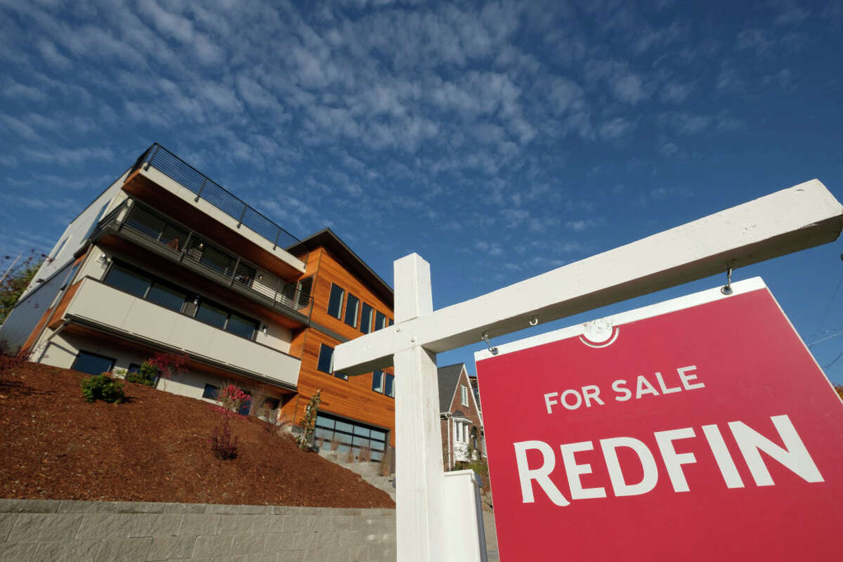 A Redfin real estate yard sign is pictured in front of a house for sale on October 31, 2017 in Seattle, Washington. 