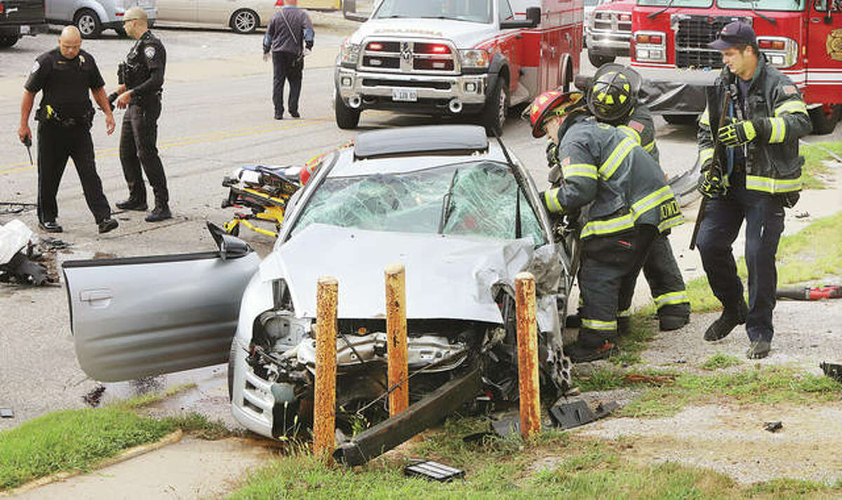 Alton firefighters use a hydraulic rescue tool Thursday afternoon to free the driver of a Mitsubishi Eclipse who collided with a Chevrolet Traverse in the 1100 block of Milton Road.