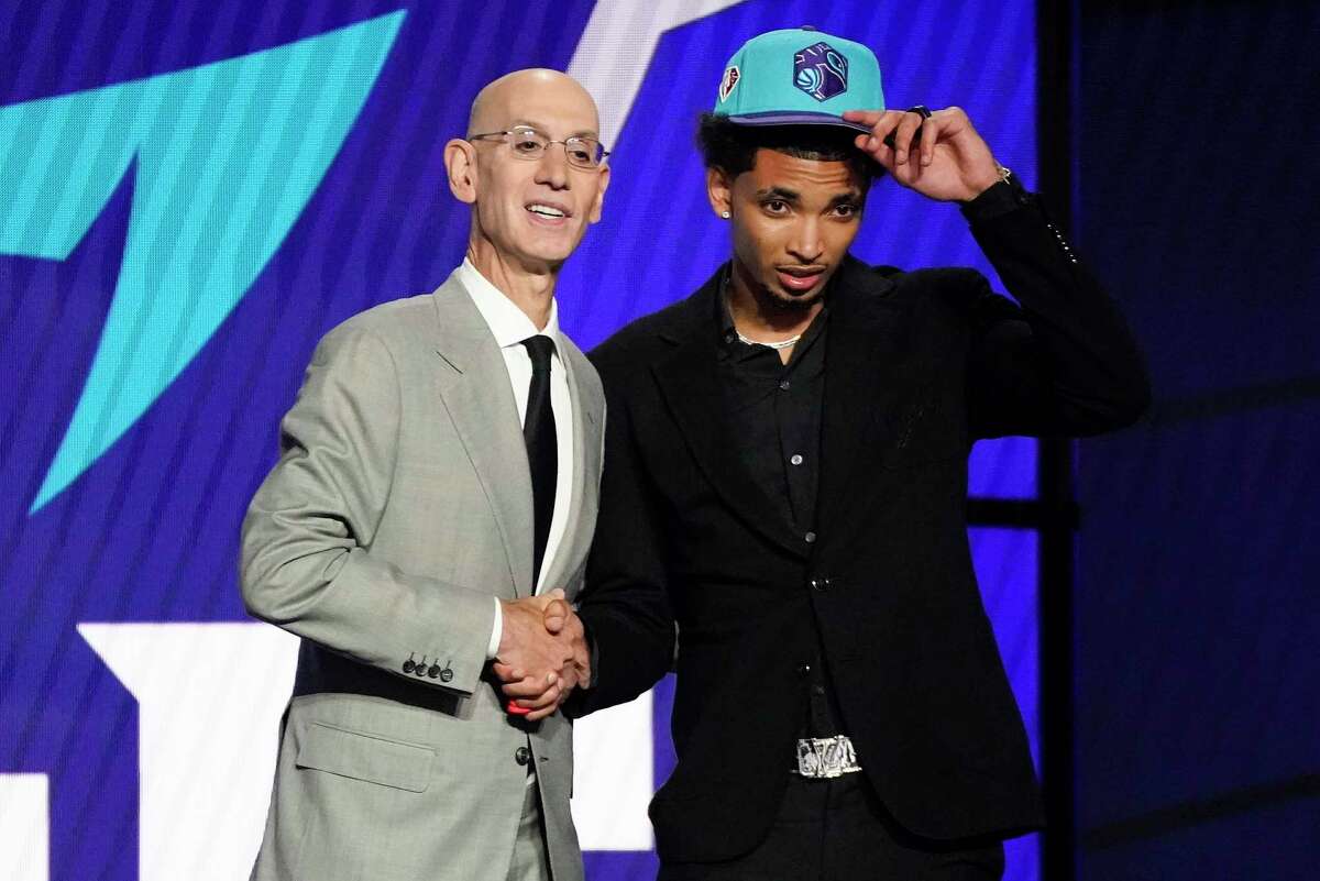 James Bouknight, right, poses for a photo with NBA Commissioner Adam Silver after being selected 11th overall by the Charlotte Hornets in the NBA Draft on Thursday.