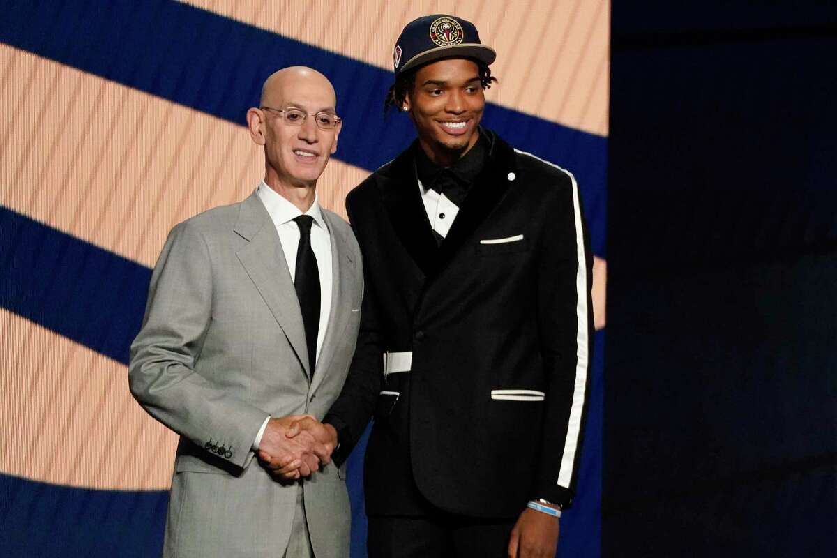 Ziaire Williams, right, poses for a photo with NBA Commissioner Adam Silver after being selected tenth overall by the New Orleans Pelicans during the NBA basketball draft, Thursday, July 29, 2021, in New York. (AP Photo/Corey Sipkin)