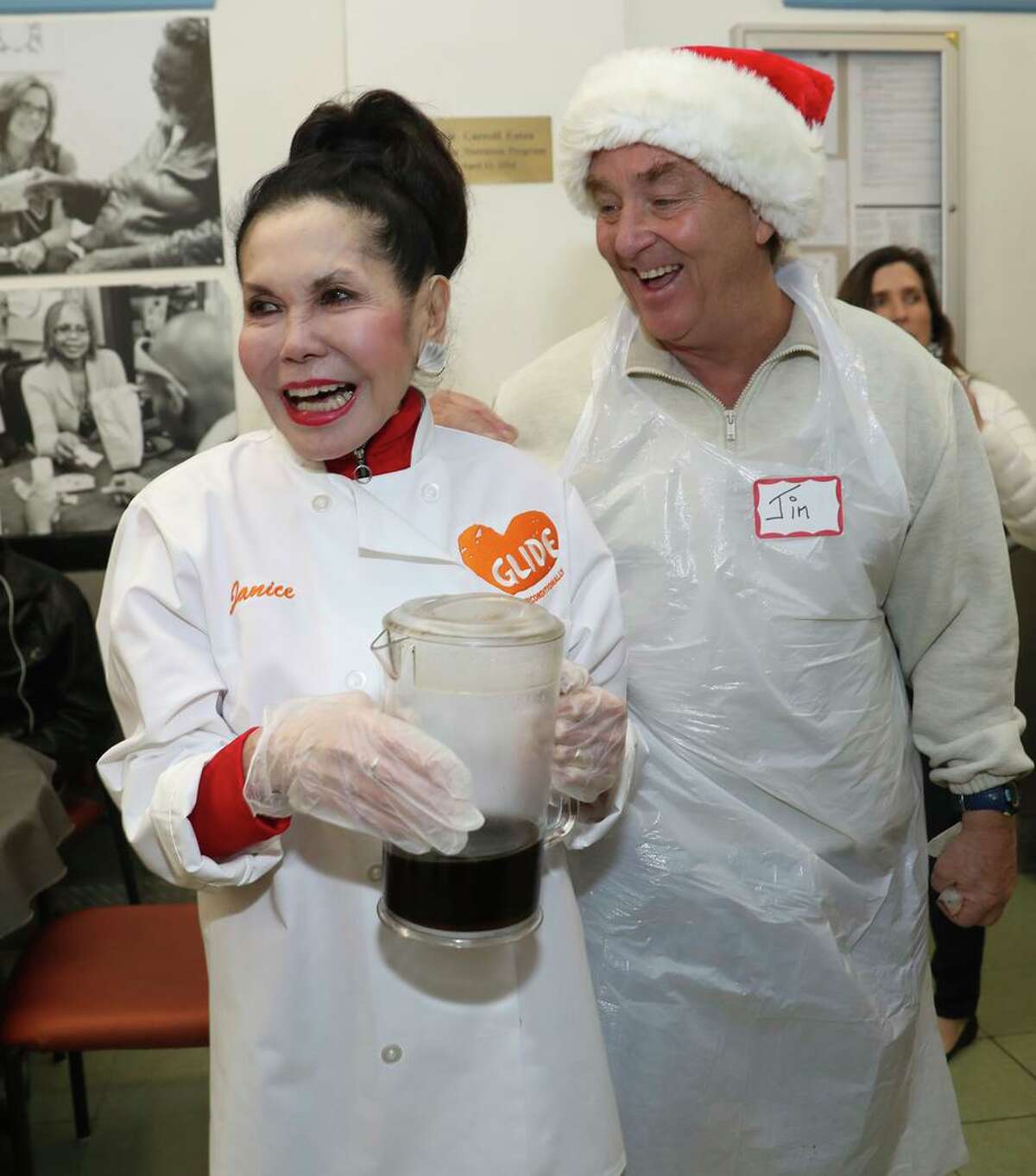 Glide Memorial Church co-founder Janice Mirikitani serves a Christmas Eve lunch in 2019 with volunteer Jim Steyer.