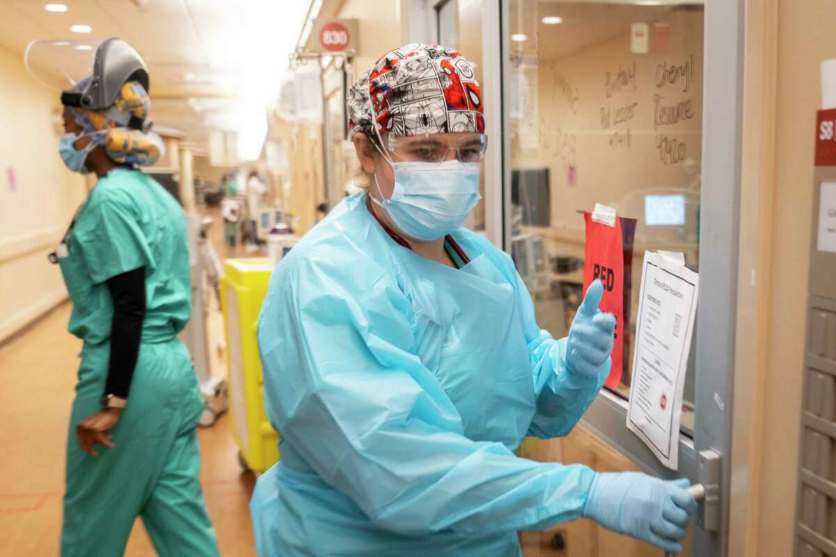Memorial Hermann Hospital respiratory therapist Angela Detert prepares to enter a patient's room inside a 38-bed ICU treating mostly COVID patients, Tuesday, Jan. 5, 2021, in Houston's Texas Medical Center.