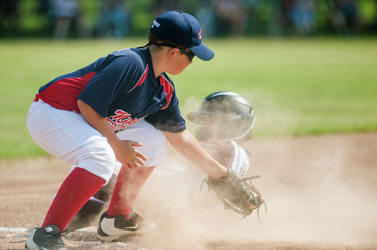 Fraternal Northwest's Brayden Robinson attempts to tag a runner at third base during a July 27, 2021 Little League 11U state quarterfinal vs. Dexter at Bay City's DeFoe Park. Robinson drove in a run and made a couple of great plays at third in Tuesday's 4-3 loss to Union Township in a major (12U) district losers' bracket final, July 12, 2022.