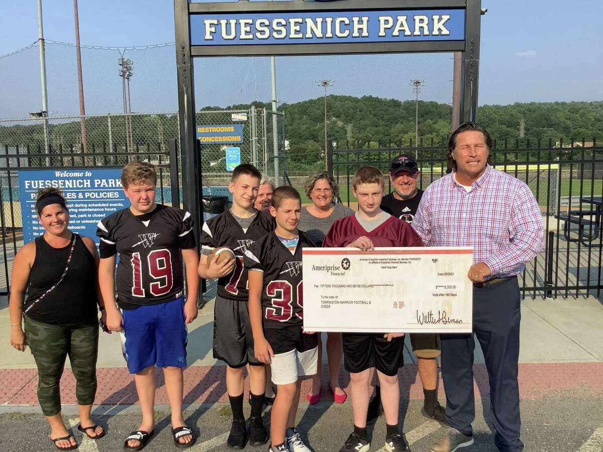 At Fuessenich Park July 27, checks for $15,000 each were presented to representatives from American Legion Baseball, the Torrington Warrior Football program, and Torrington Youth Soccer. Jonathon Root, right, with the Warriors, presented the money to each group on behalf of an anonymous donor.