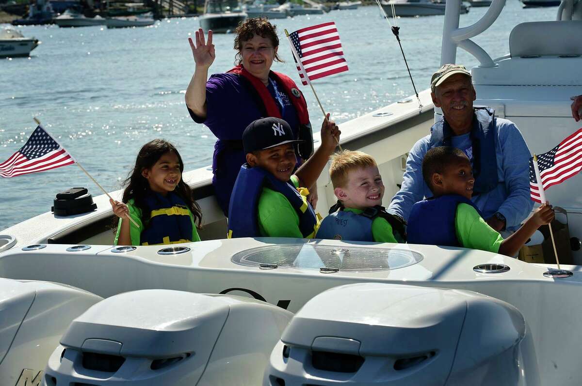 Campers from ROSCCO (Rogers School Community Center Organization) summer vacation program enjoy the water during the Noroton Yacht Club's 25th annual Boat/Camp Friday July 30, 2021, at the Yacht Club in Darien, Conn. Person-to-Person, Darien Boat Club, Darien Police Marine Unit, Noroton Fire Department, Norwalk Seaport Association, United States Coast Guard Auxiliary--Norwalk Flotilla 72 and Darien Sail and Power Squadron partner to provide a safe on-the-water experience for underserved children.