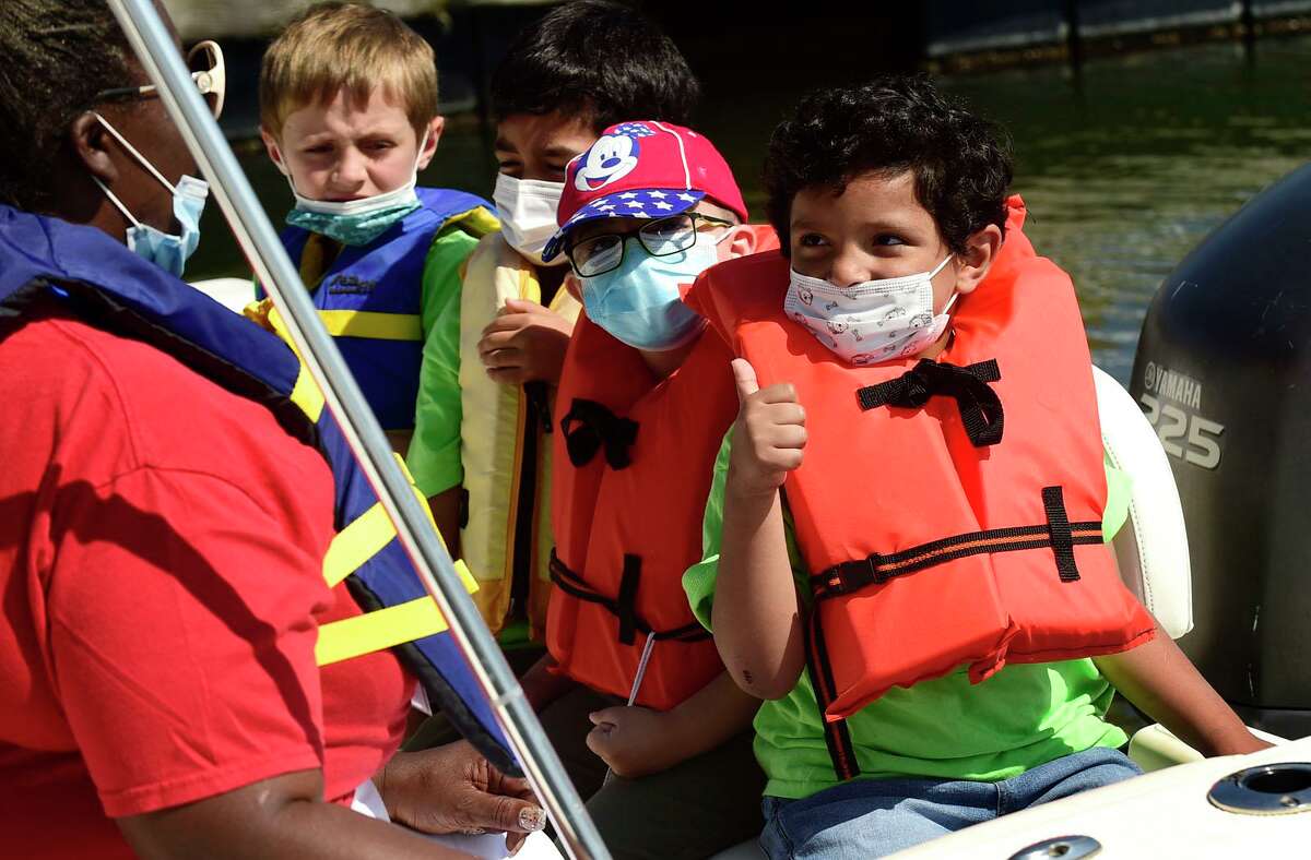 Campers from ROSCCO (Rogers School Community Center Organization) summer vacation program including Jacob Bisono enjoy the water during the Noroton Yacht Club's 25th annual Boat/Camp Friday July 30, 2021, at the Yacht Club in Darien, Conn. Person-to-Person, Darien Boat Club, Darien Police Marine Unit, Noroton Fire Department, Norwalk Seaport Association, United States Coast Guard Auxiliary--Norwalk Flotilla 72 and Darien Sail and Power Squadron partner to provide a safe on-the-water experience for underserved children.