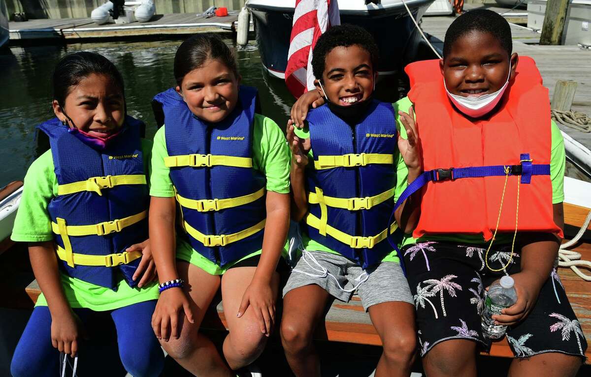 Campers from ROSCCO (Rogers School Community Center Organization) summer vacation program including Jacqueline Perez, Leah Molino, Ayden Enfantis and Nojah Dior Dixon, enjoy the water during the Noroton Yacht Club's 25th annual Boat/Camp Friday July 30, 2021, at the Yacht Club in Darien, Conn. Person-to-Person, Darien Boat Club, Darien Police Marine Unit, Noroton Fire Department, Norwalk Seaport Association, United States Coast Guard Auxiliary--Norwalk Flotilla 72 and Darien Sail and Power Squadron partner to provide a safe on-the-water experience for underserved children.