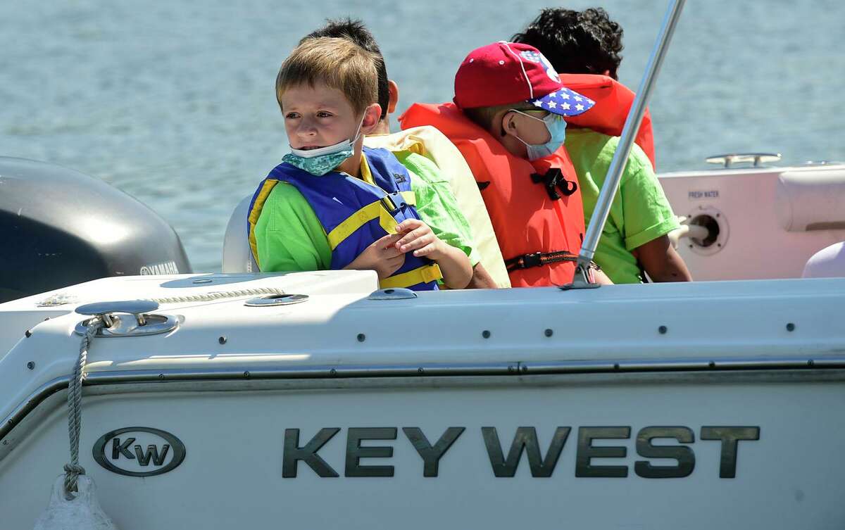 Campers from ROSCCO (Rogers School Community Center Organization) summer vacation program enjoy the water during the Noroton Yacht Club's 25th annual Boat/Camp Friday July 30, 2021, at the Yacht Club in Darien, Conn. Person-to-Person, Darien Boat Club, Darien Police Marine Unit, Noroton Fire Department, Norwalk Seaport Association, United States Coast Guard Auxiliary--Norwalk Flotilla 72 and Darien Sail and Power Squadron partner to provide a safe on-the-water experience for underserved children.