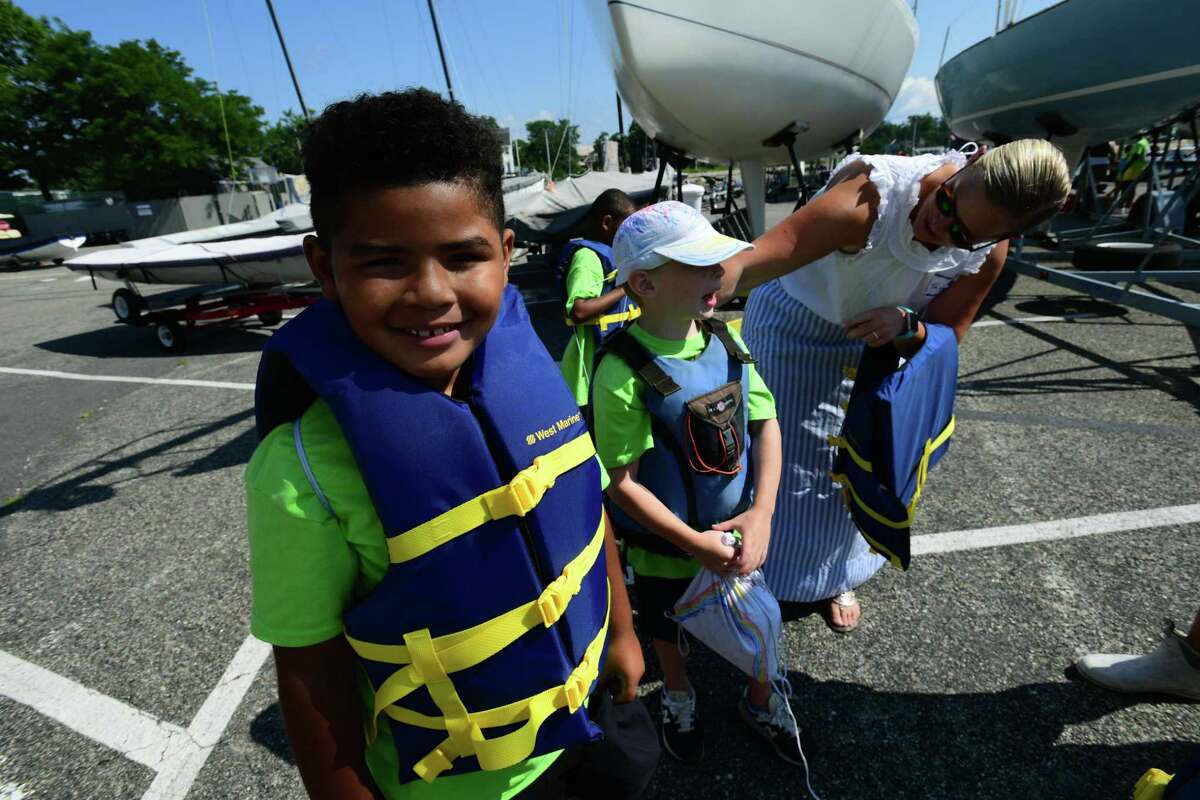 Campers from ROSCCO (Rogers School Community Center Organization) summer vacation program enjoy the water during the Noroton Yacht Club's 25th annual Boat/Camp Friday July 30, 2021, at the Yacht Club in Darien, Conn. Person-to-Person, Darien Boat Club, Darien Police Marine Unit, Noroton Fire Department, Norwalk Seaport Association, United States Coast Guard Auxiliary--Norwalk Flotilla 72 and Darien Sail and Power Squadron partner to provide a safe on-the-water experience for underserved children.