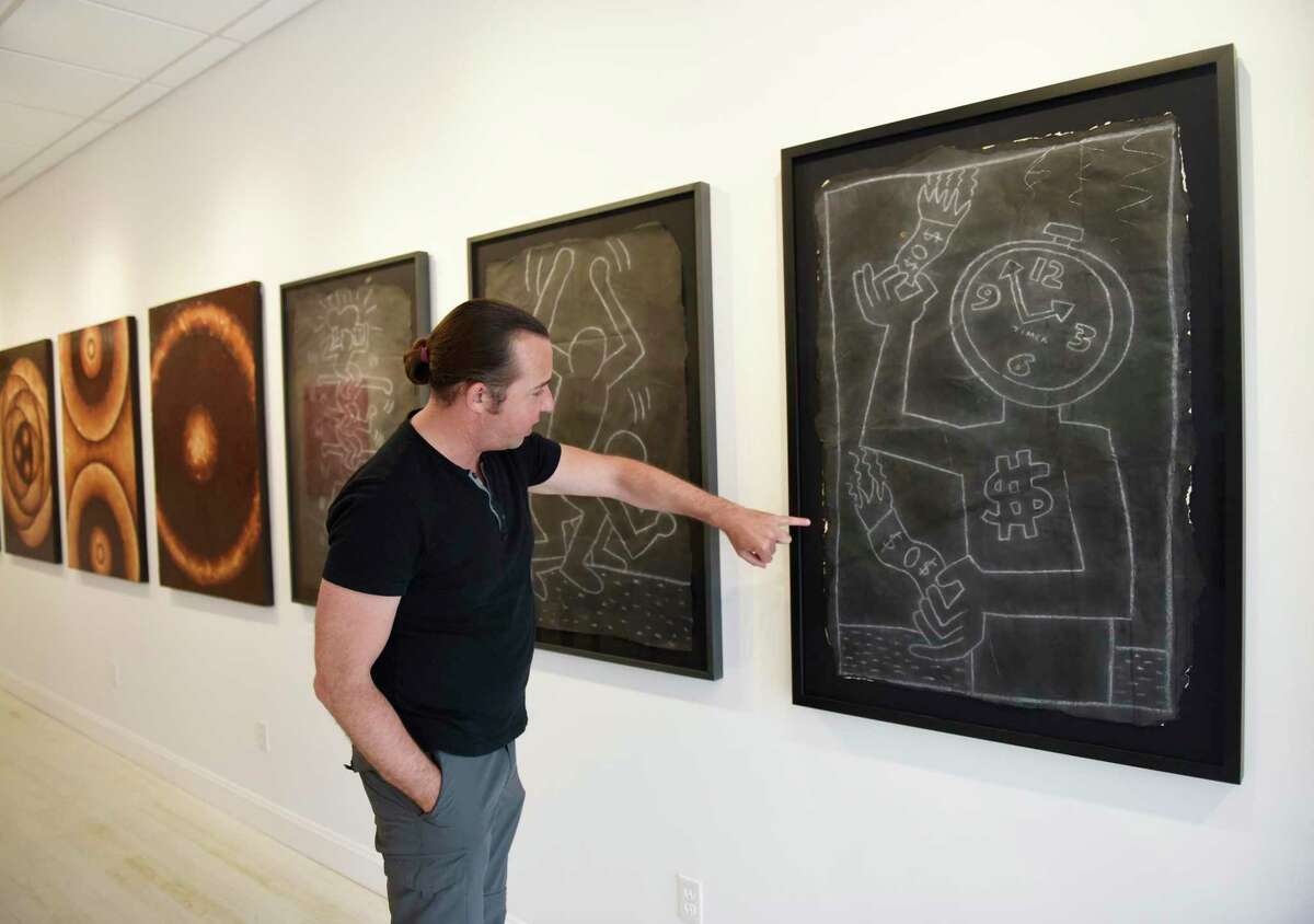 Managing Director and Co-Owner Alex Trimper shows chalk drawings from renowned artist Keith Haring recovered from New York City Subway stations in the 1980s at Isabella Garrucho Fine Art in Greenwich, Conn. Thursday, July 29, 2021.