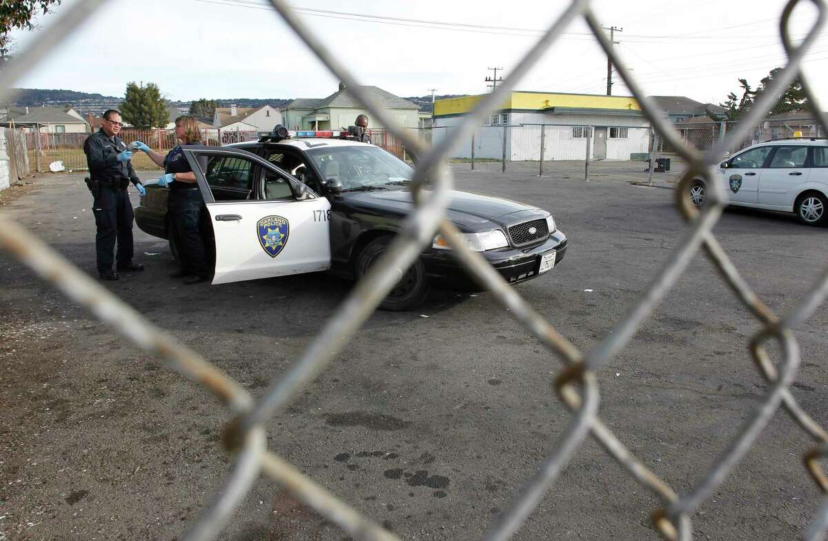 This file photograph shows Oakland police officers gathering evidence on Saturday December 31, 2011, where a 5-year-old boy was shot and killed near the corner of 55th Ave. and International Blvd. in Oakland.