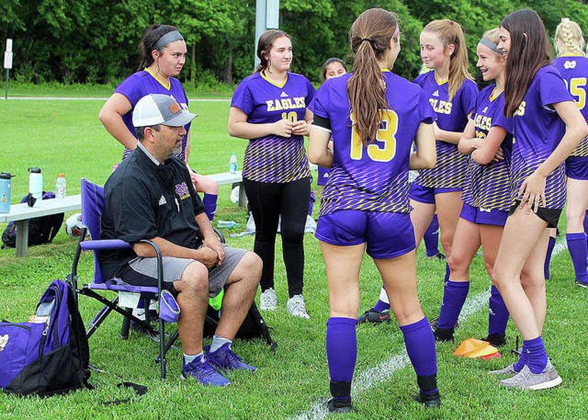 Civic Memorial coach Eric Zyung talks with his team after giving halftime instructions during CM’s 7-0 playoff victory over Charleston at the Bethalto Sports Complex.