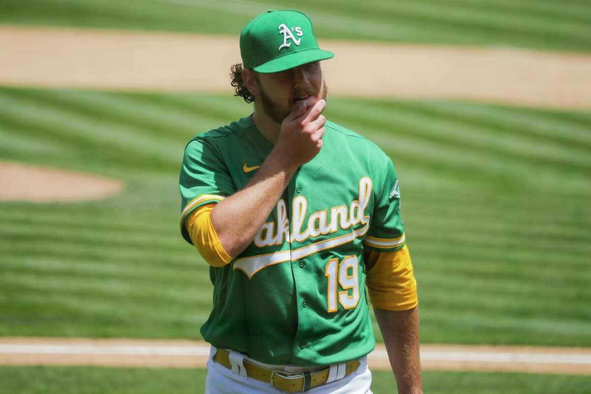 Cole Irvin (19) returns to the dugout after being relieved during the sixth inning as the Oakland Athletics played the Los Angeles Angels at the Coliseum in Oakland, Calif. Wednesday, June 16, 2021. The A?•s defeated the Angels 8-4.