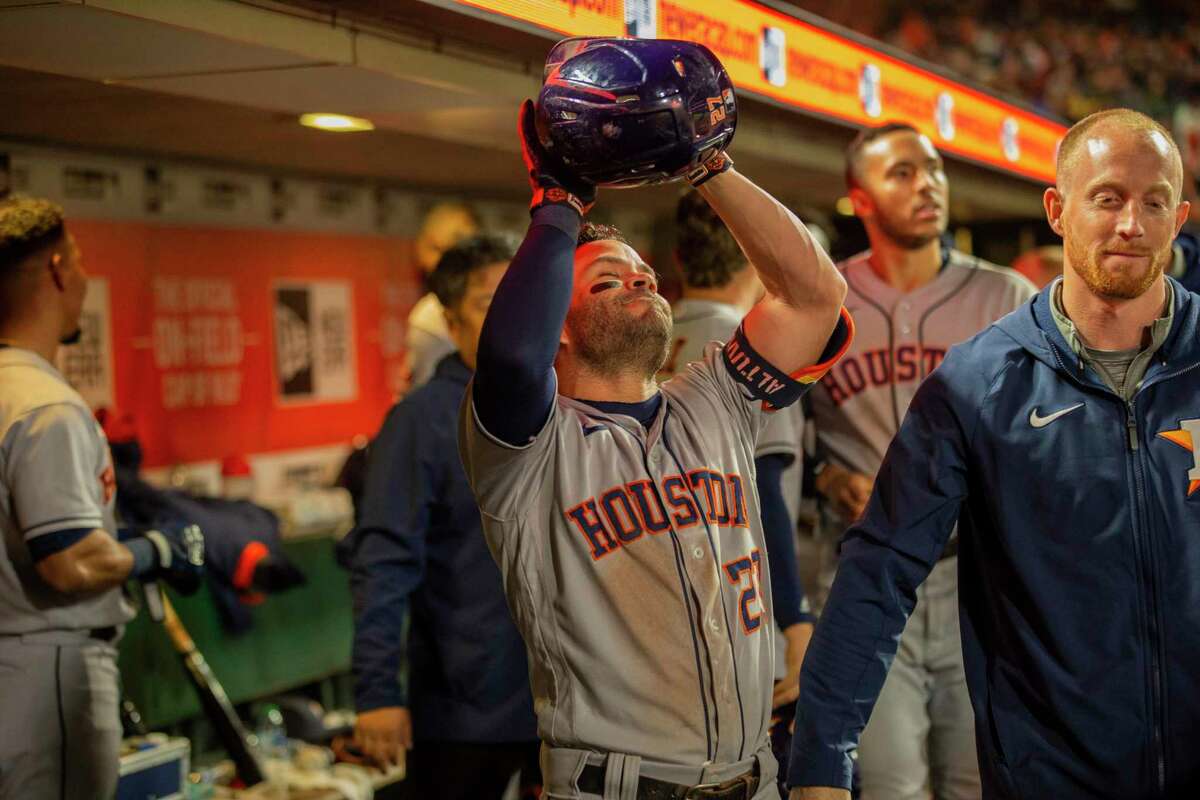 Houston Astros second baseman Jose Altuve (27) celebrates in the dugout after his grand slam home run in the sixth inning during an MLB game at Oracle Park, Friday, July 30, 2021, in San Francisco, Calif.