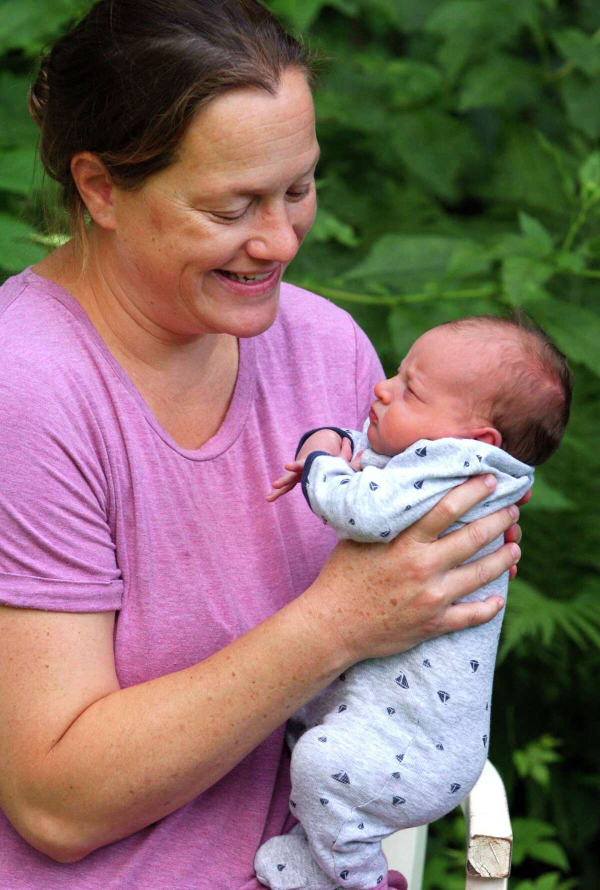 Jenn Zazula holds her one-week-old son Luke at her home in Greenwich, Conn., on Saturday July 31, 2021. Even before COVID-19 hit, quality day care centers were in high demand. Now, with parents returning to work, it has been difficult for many to find childcare openings in the area.