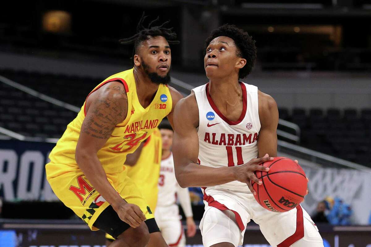 INDIANAPOLIS, INDIANA - MARCH 22: Joshua Primo #11 of the Alabama Crimson Tide handles the ball against Donta Scott #24 of the Maryland Terrapins in the second half in the second round game of the 2021 NCAA Men's Basketball Tournament at Bankers Life Fieldhouse on March 22, 2021 in Indianapolis, Indiana. (Photo by Stacy Revere/Getty Images)