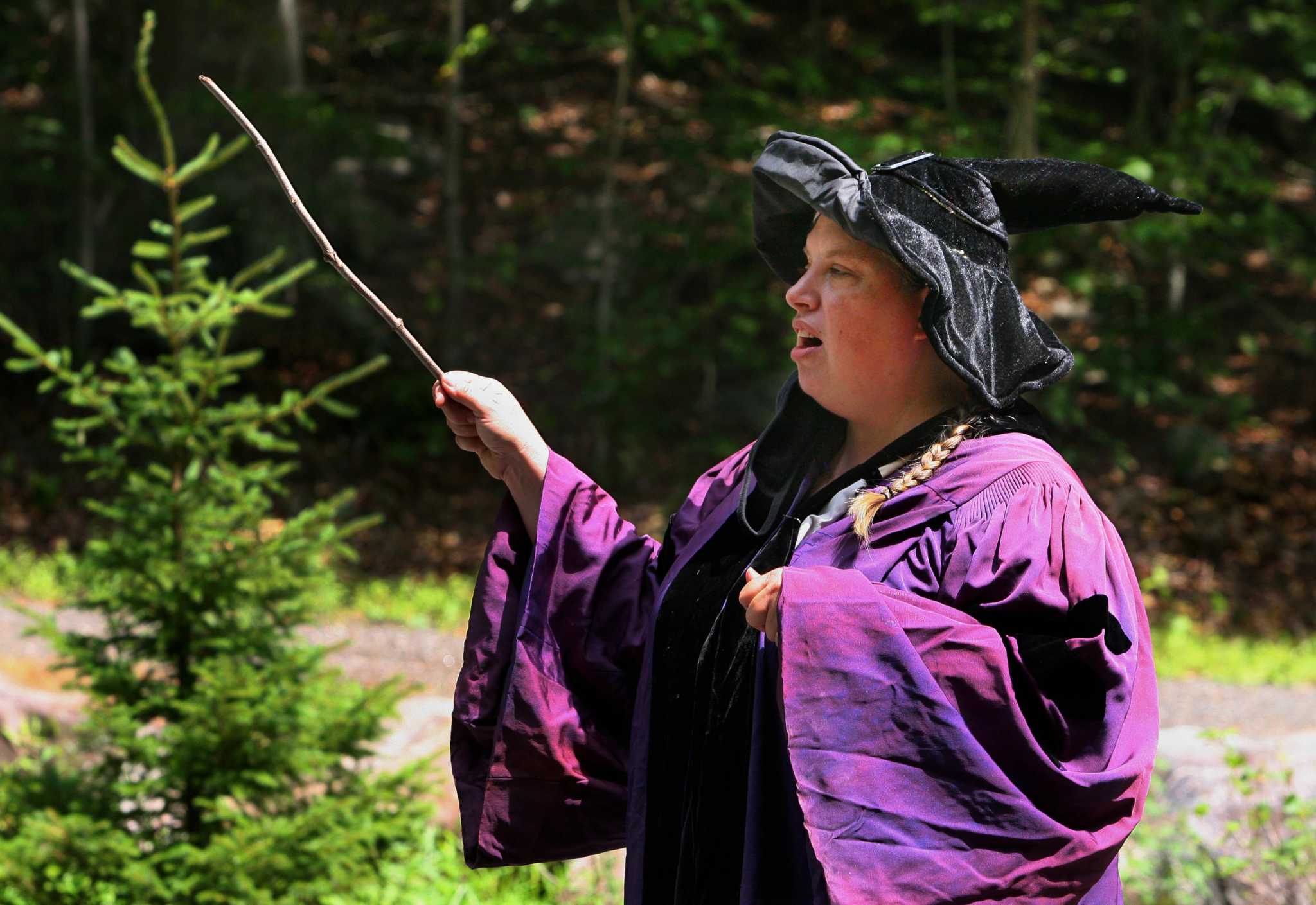 Professor Quickwit, played by Stamford Museum & Nature Center Director of Education Lisa Monachelli, teaches kids how to use their magic wands during a potions class as part of a Wizard Picnic to celebrate Harry Potter's birthday on the grounds in Stamford, Conn., on Saturday July 31, 2021. Kids came dressed as wizards and took part in several activities like making their own wands, a potions class, a visit with some magical creatures from the nature center and snacks.
