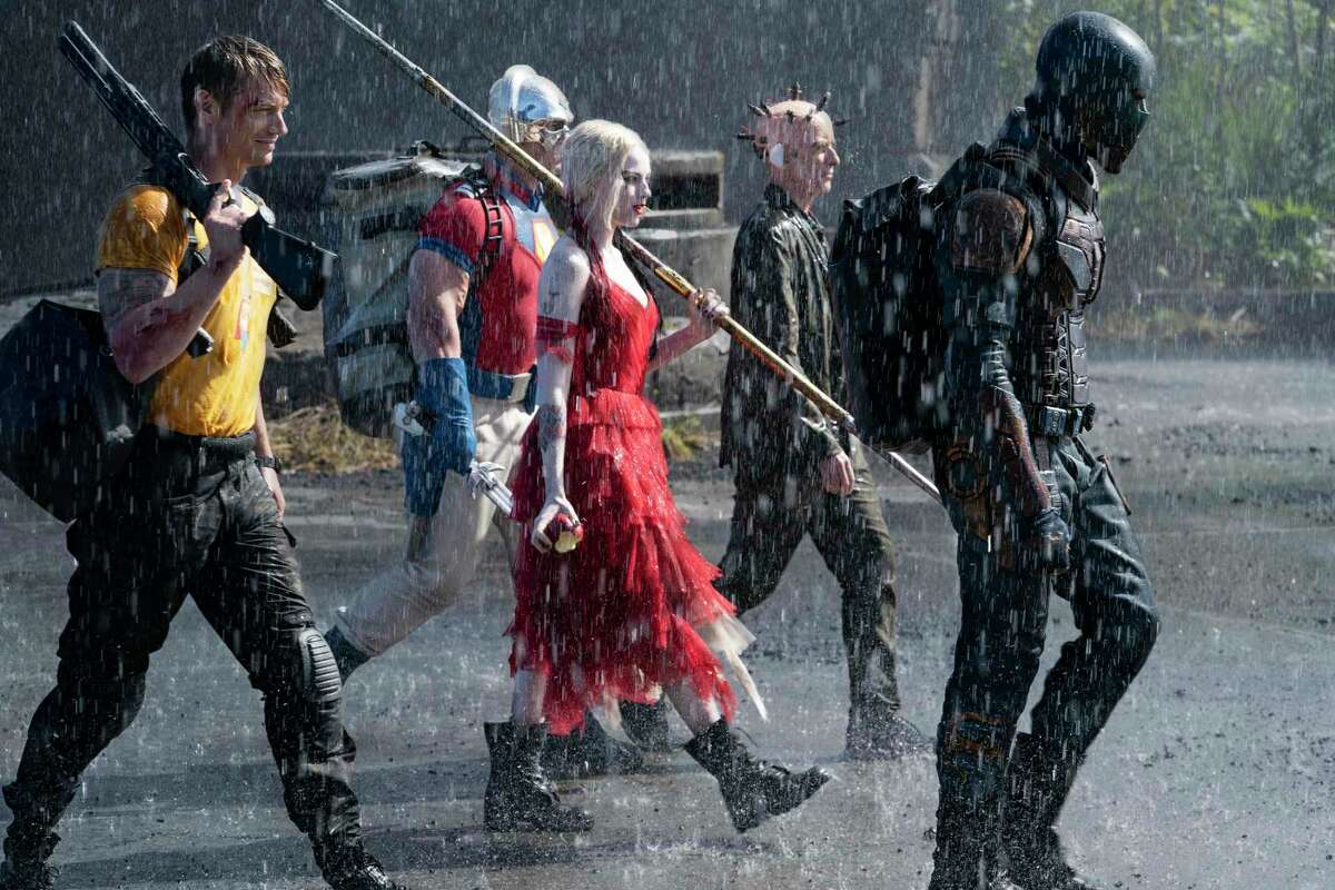 This image provided by Warner Bros. Pictures shows Joel Kinnaman, from left, John Cena, Margot Robbie, Peter Capaldi and Idris Elba in a scene from “The Suicide Squad.”