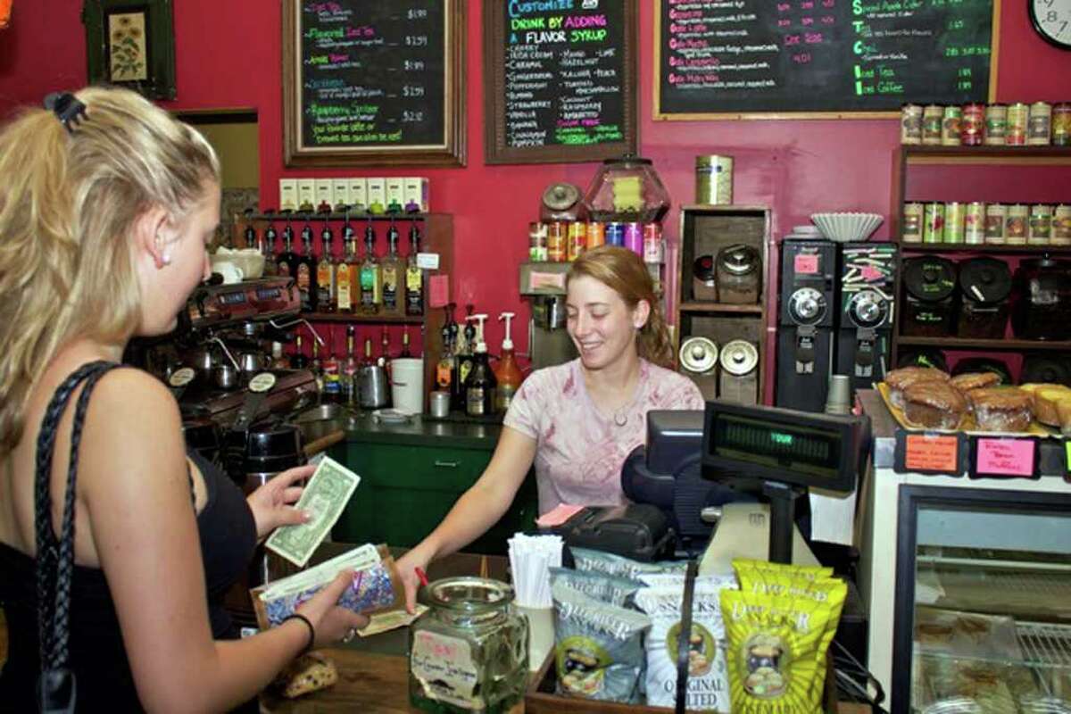 Ramona Borz, left, of New Milford and Germany, buys coffee from Shannon Gallagher of Washington at The Bank Street Coffee House in New Milford.