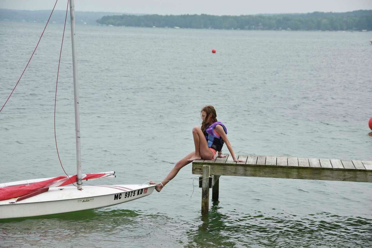 One of the Sunfish participants waits for her racing partner prior tot he start of the race on Saturday at Portage Lake. (Arielle Breen/News Advocate)