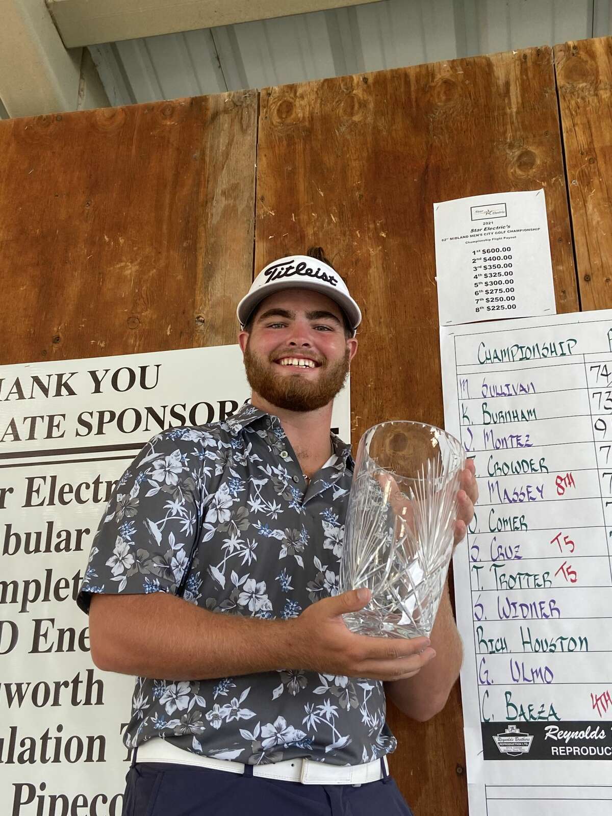 Davis Seybert holds the glass vase trophy after winning the Star Electric Midland Men's City Championship on Aug. 1 at Hogan Park Golf Course. 
