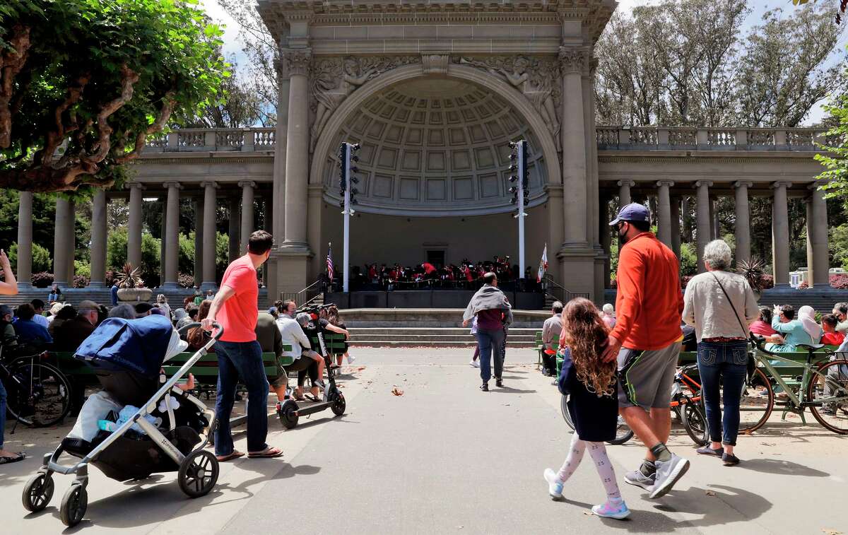 Visitors walk to their seats as the Golden Gate Park Band plays in San Francisco.