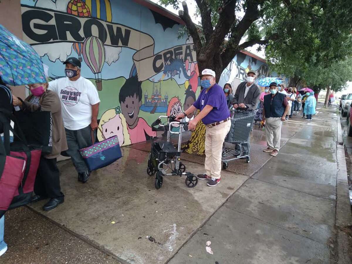 People wait in line for food at Laredo’s Holding Institute on July 8, 2021.
