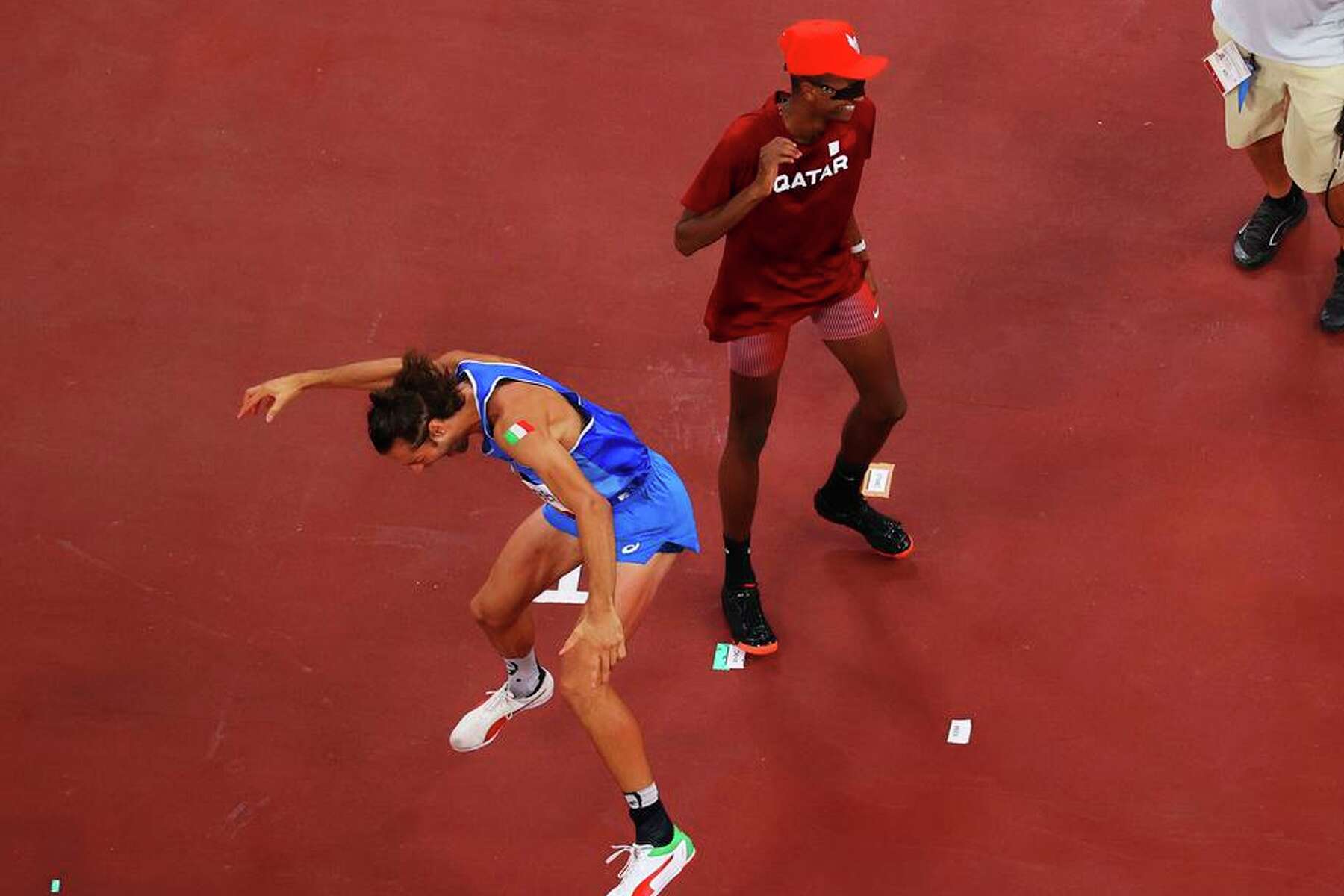 friends jubilant at being able to share olympic gold medal in high jump