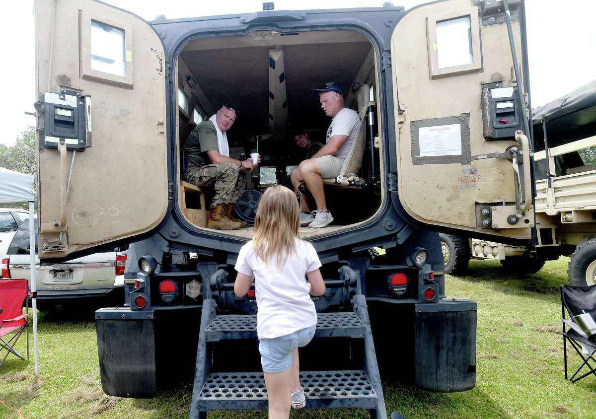 Children tour the many emergency vehicles on display during the annual Orange County Sheriff's Cops and Kids Picnic Friday in Claiborne Park. Photo made Friday, July 30, 2021 Kim Brent/The Enterprise
