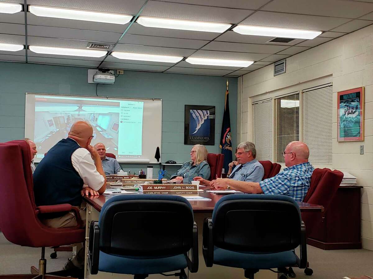 The Huron County Commissioners talk before last week's meeting, where they made adjustments to the county expo center's rental rates. (Robert Creenan/Huron Daily Tribune)
