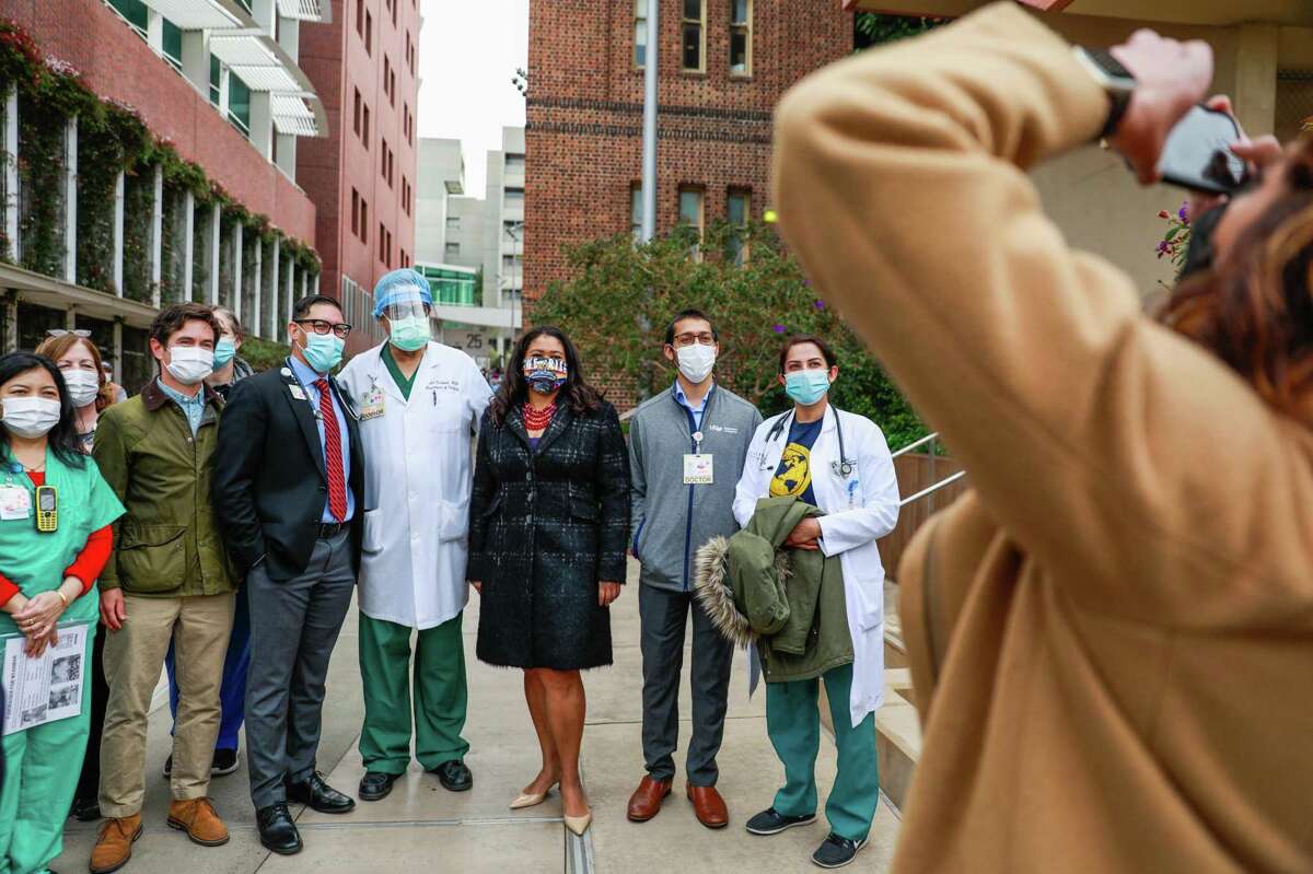 Mayor London Breed (center) and masked staff members at San Francisco General Hospital mark the one year anniversary of the COVID-19 pandemic shutdown in March. After tapering off, cases in the Bay Area now have risen above the peak rates of the summer of 2020.