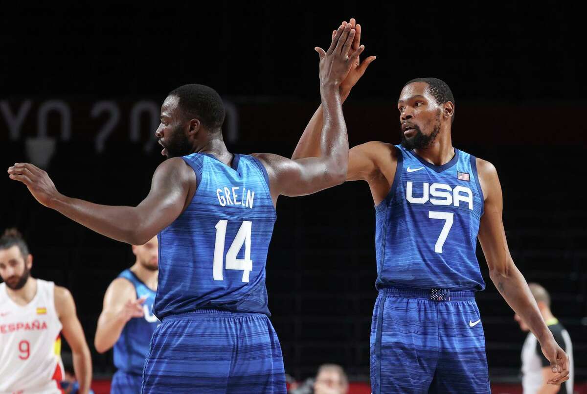 Draymond Green high-fives teammate Kevin Durant during the first half of their Men's Basketball Quarterfinal game against Spain on day eleven of the Tokyo 2020 Olympic Games at Saitama Super Arena on August 03, 2021 in Saitama, Japan.