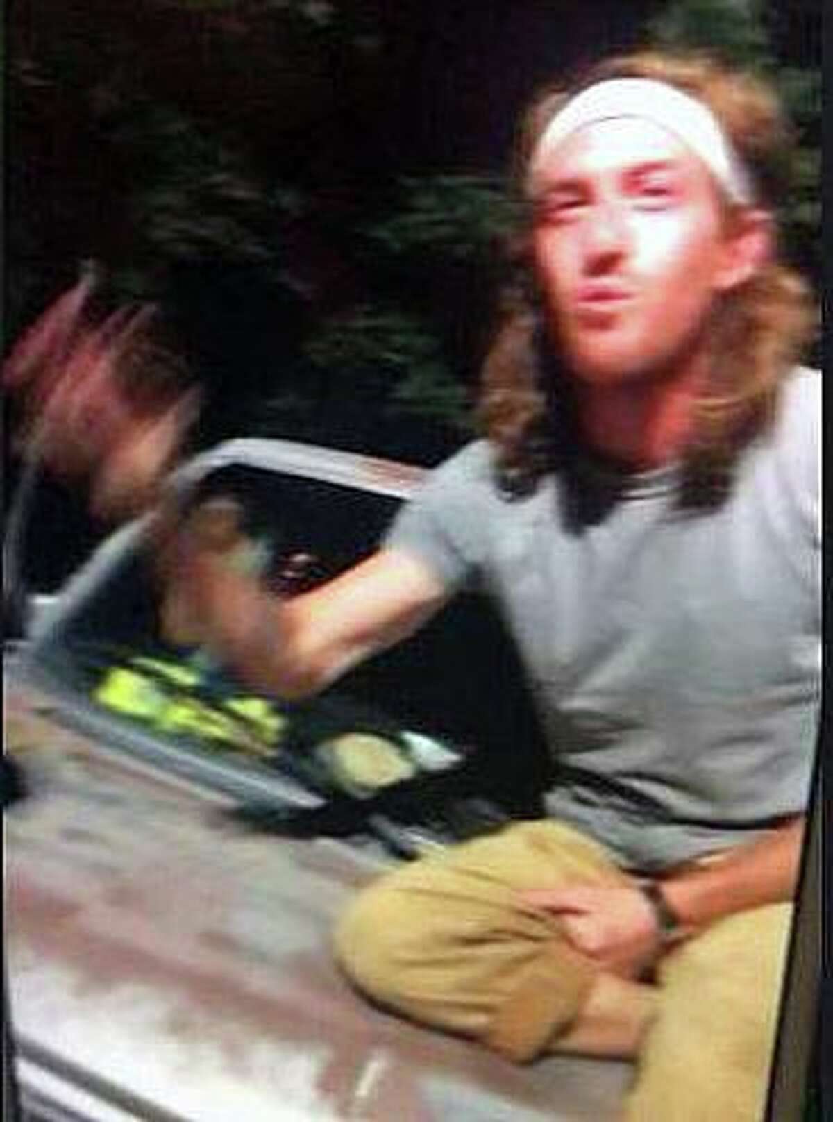 Witnesses told police the man chased people with an ax and threatened them in a Southington, Conn., parking lot on Saturday, July 31, 2021. Police said he also intentionally damaged a car with the ax.