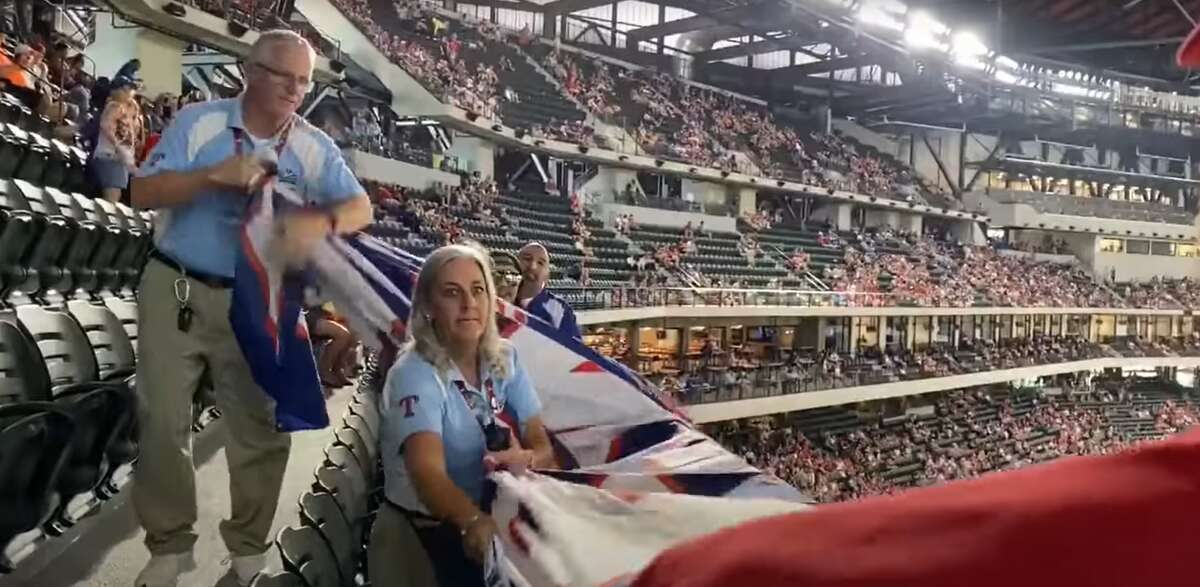 A video uploaded to YouTube by Elan News shows three Texas Rangers security guards descended the stairs and told Shroyer to immediately remove the pro-Trump flag. 