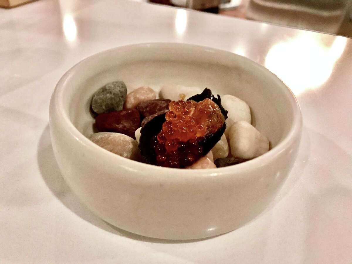 Mussel escabeche with salmon roe on a pebble bed