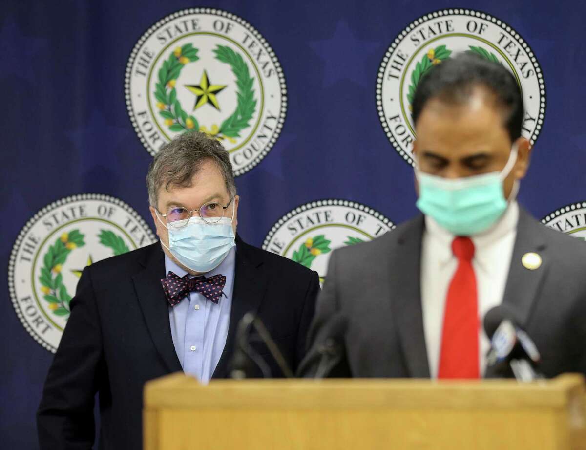 Co-director of the Center for Vaccine Development at Texas Children’s Hospital Dr. Peter Hotez, left, looks at Fort Bend County Judge KP George who talked to reporters during a press conference about the COVID-19 risk level for the county being increased on Tuesday, Aug. 3, 2021, in Richmond.