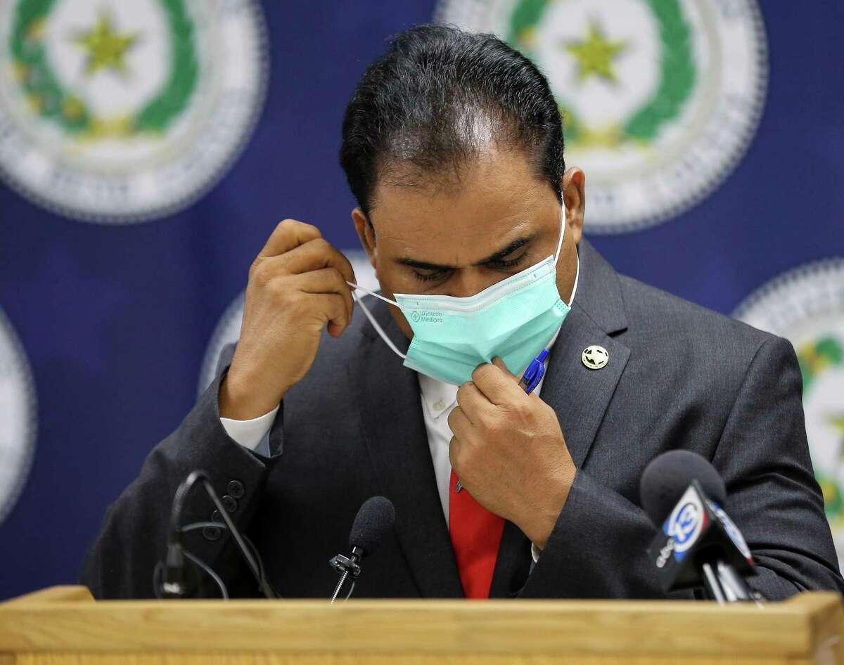 Fort Bend County Judge KP George puts his face mask back on after he talked to reporters at a press conference in which he indicated the COVID-19 risk level has been increased for the county on Tuesday, Aug. 3, 2021, in Richmond.
