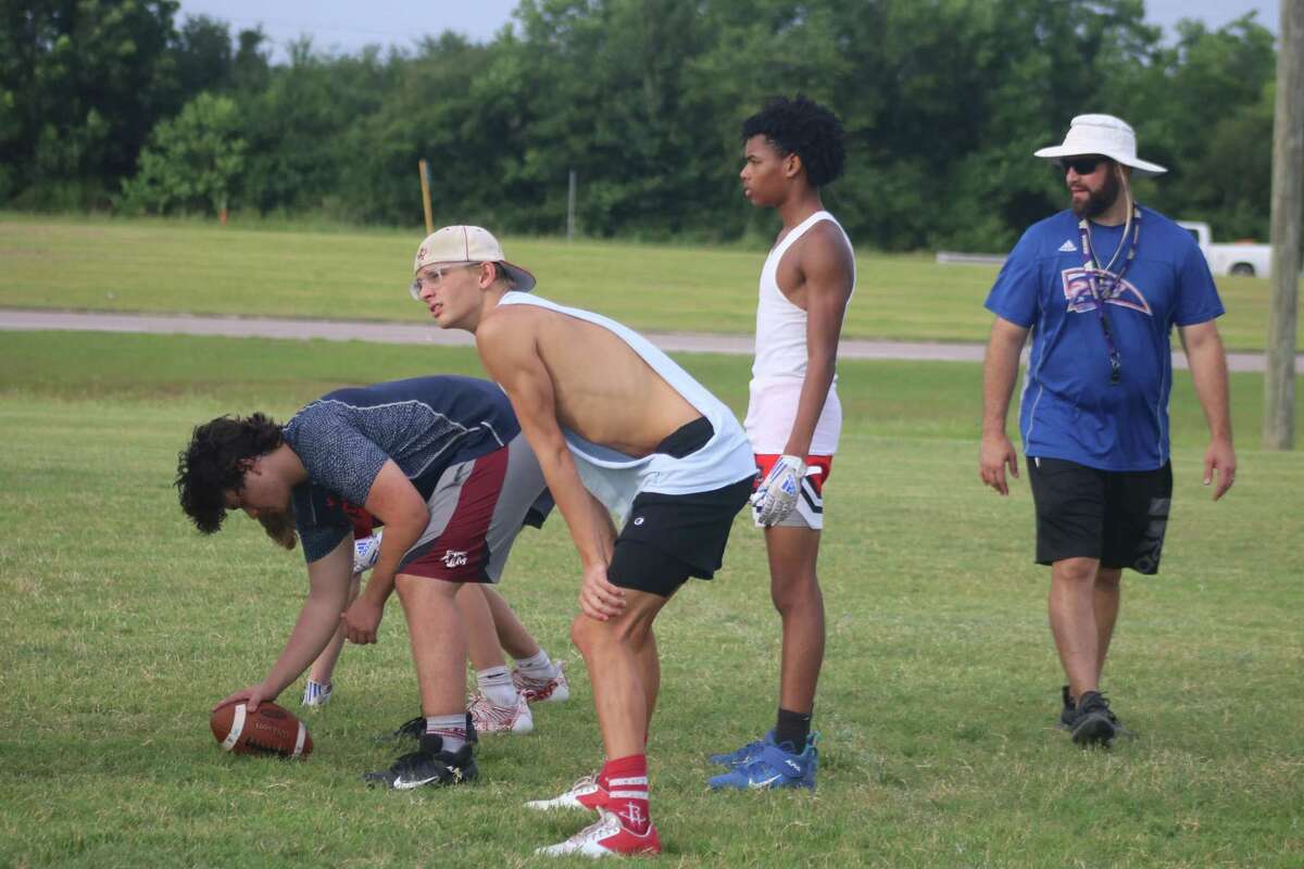 Pasadena-First Baptist Christian Academy head football coach Justin Larsen began the process Monday of preparing the program for a return to the six-man football scene. Harrison Brown, the school's medal winner at the TAPPS state swim championships in March, is pictured in the ballcap.