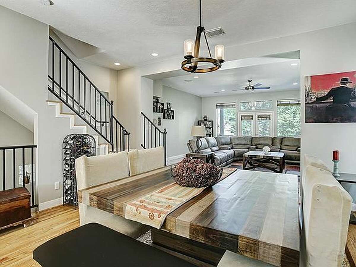 The dining area leads into a large living room.
