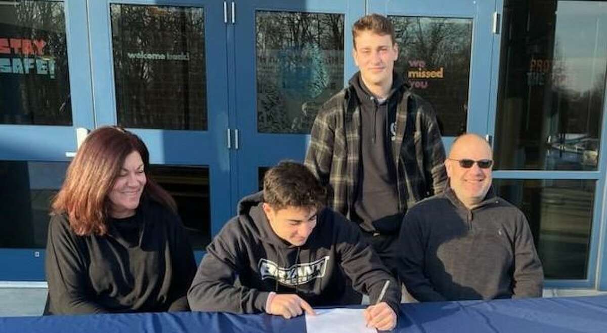 Luca Marinelli signs to play men’s soccer at Bryant University. With the Foran High All-State goalie are mom Laura, brother Andrew and dad Fabio.